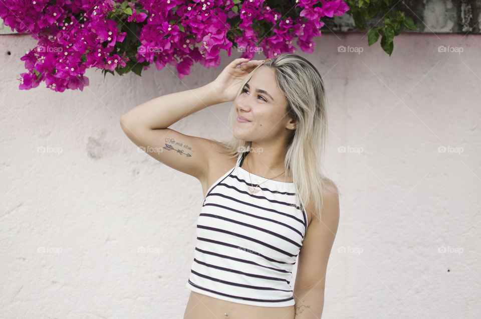 Blonde woman against pink background