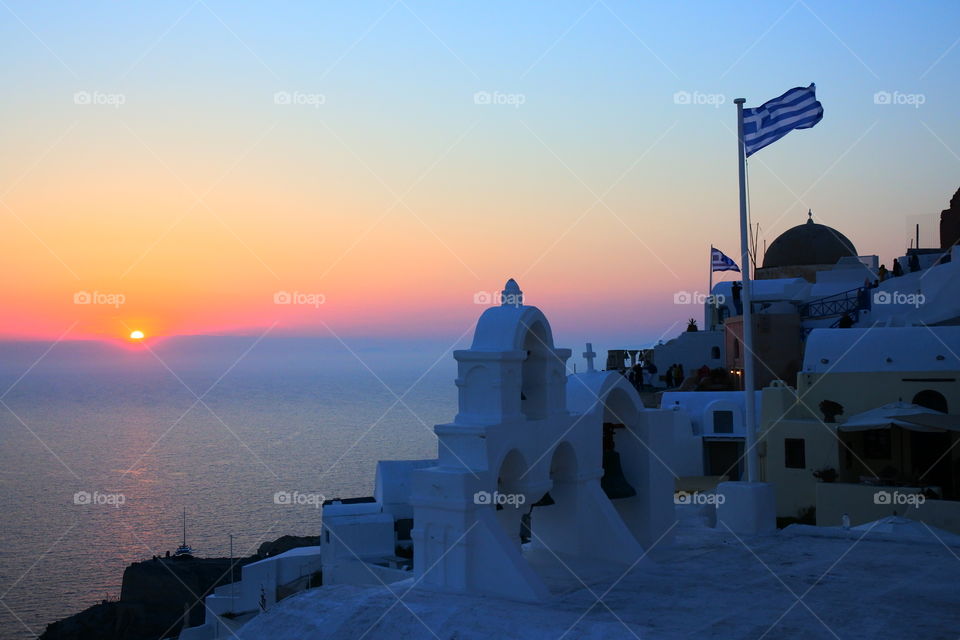 Greek flag and sun set