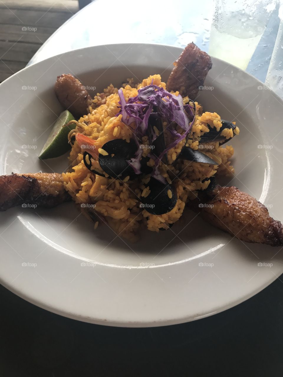A fresh Puerto Rican dish of seafood in rice with fried plantains