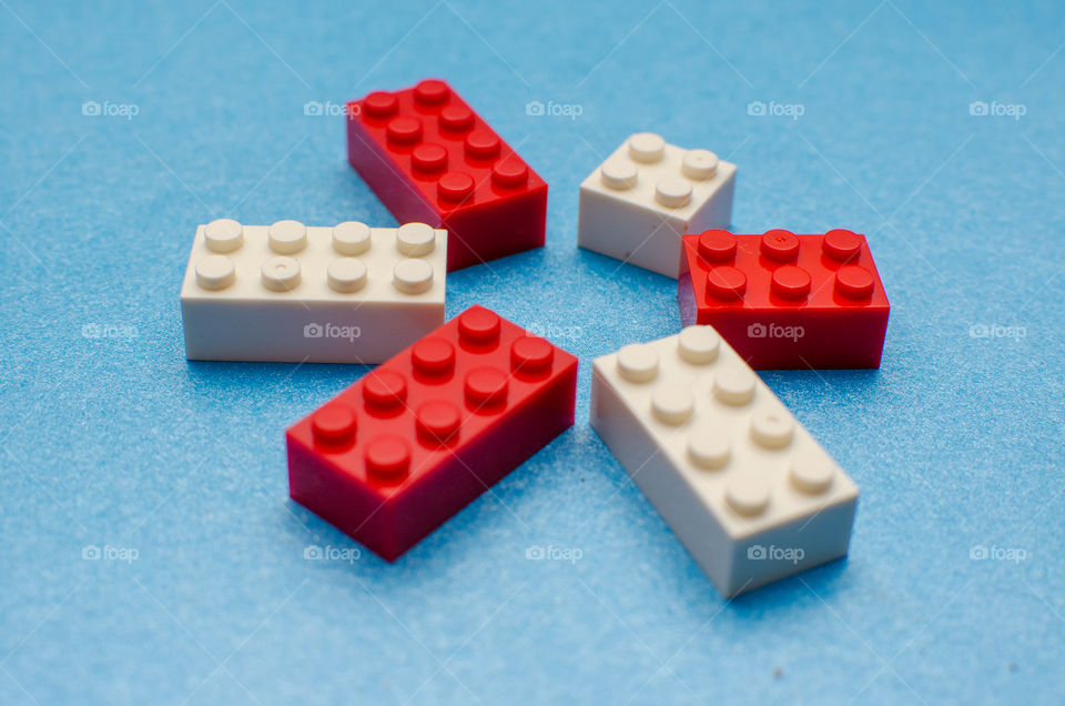 red and white Legos on blue background