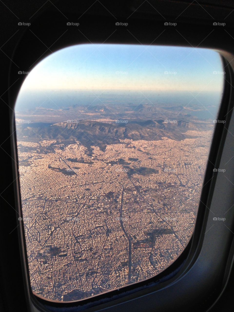 Aeroplane flying over Athens Greece, approaching Athens International airport for landing 