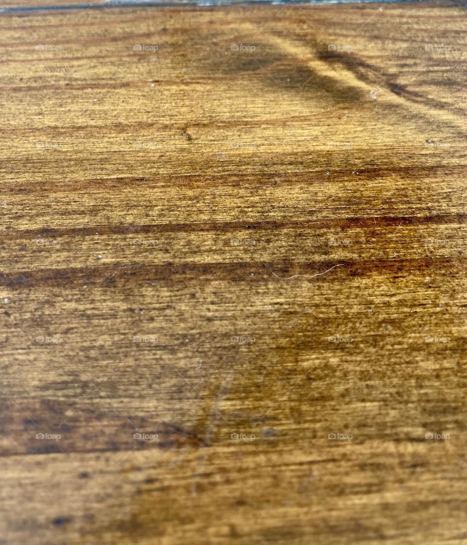 The image shows a close-up of a wooden surface.