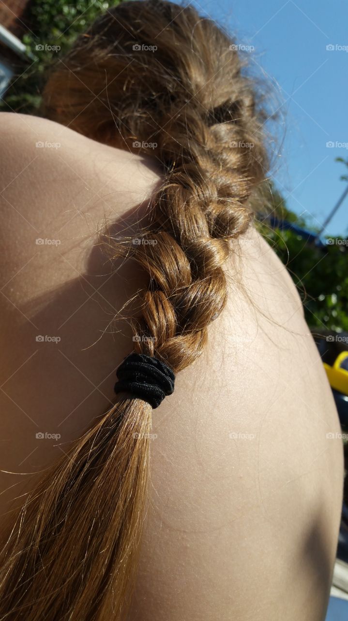 messy brown plaited hair