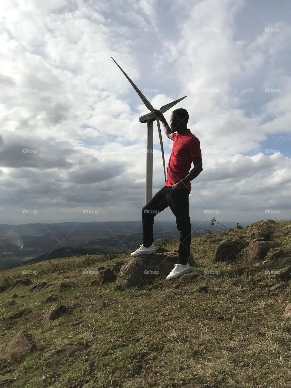 Cloud one person sky wind environment Nature full length Adult Windmill landscape mountain leisure activity day Land Standing adventure Wind power beauty in Nature outdoors Wind Turbine in Ngong, Kenya
