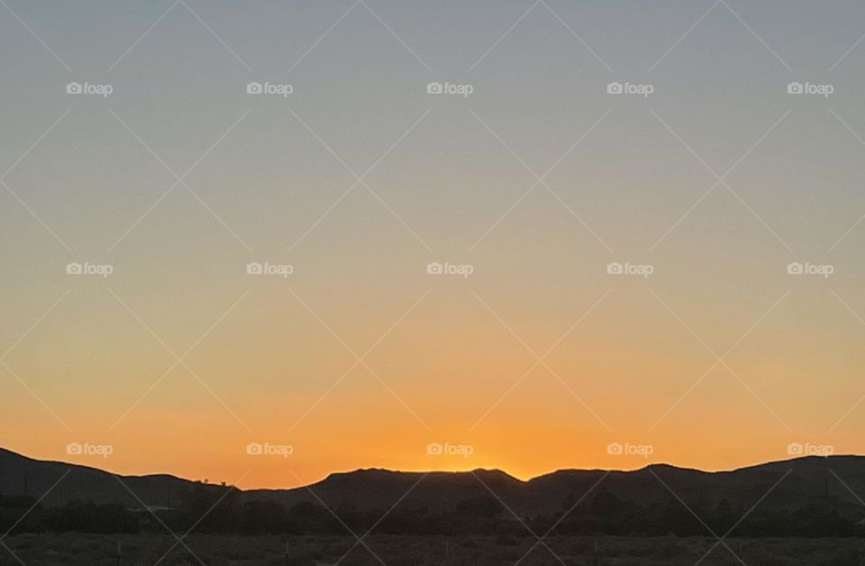 A orange sunset with mountains 