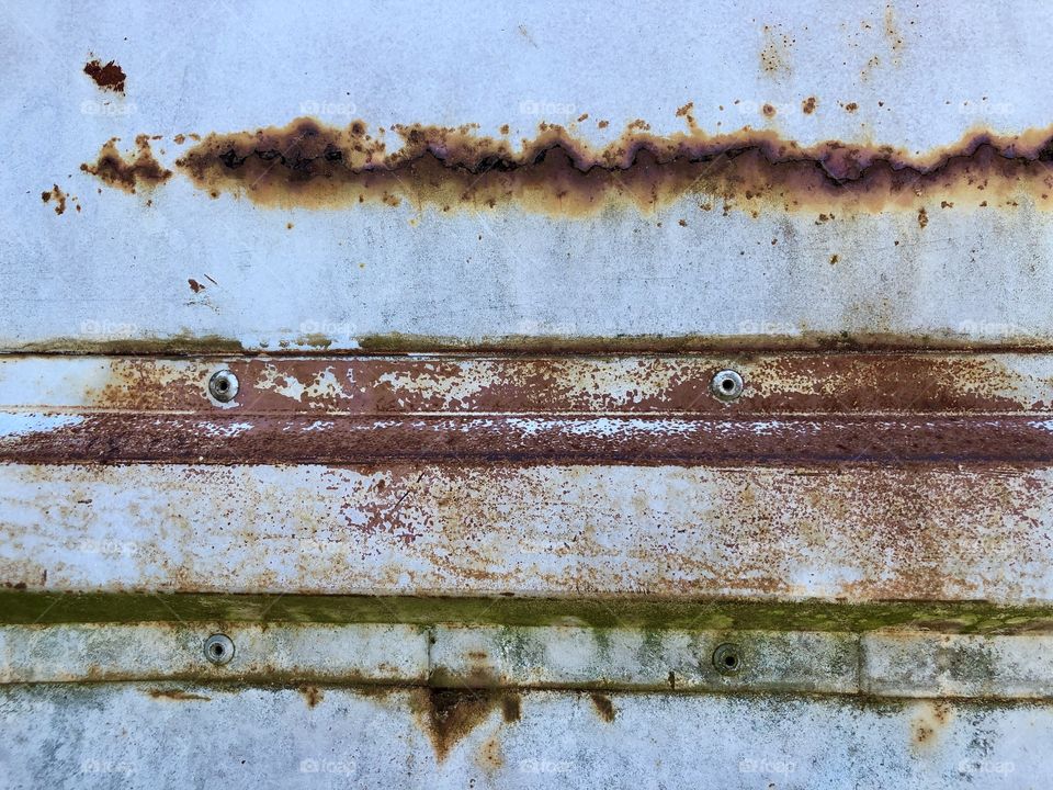 Full frame closeup of old rusting metal side panel of work truck 