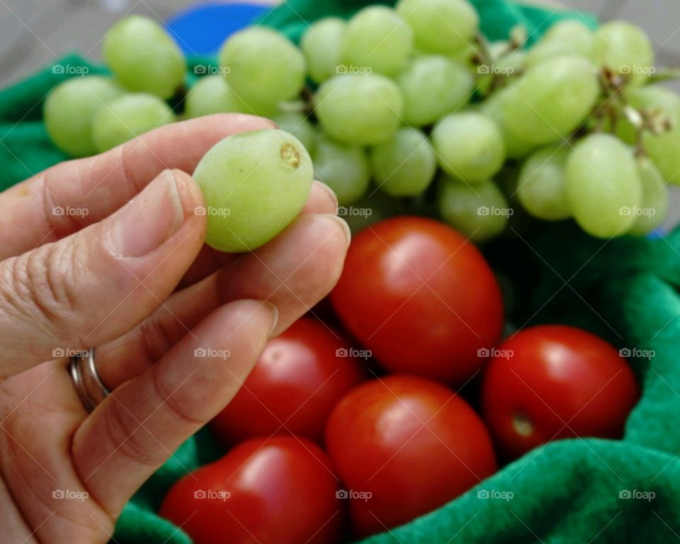 Women finger holding grape