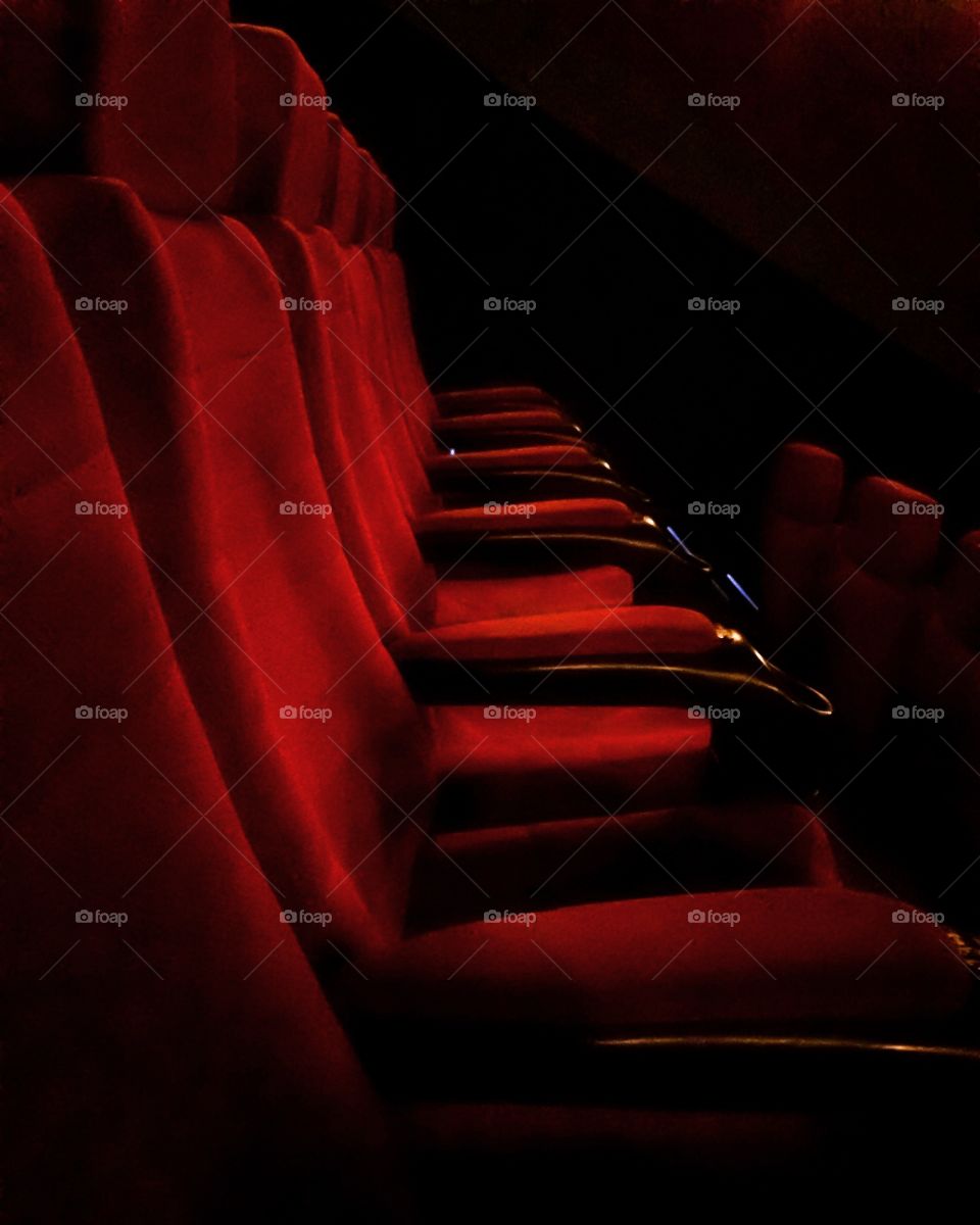 Red empty velvet seats in the audience before the performance 