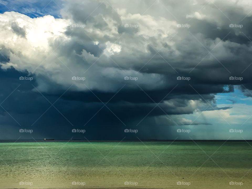 Dark miserable Storm clouds and rain in distance over ocean in south Australia 