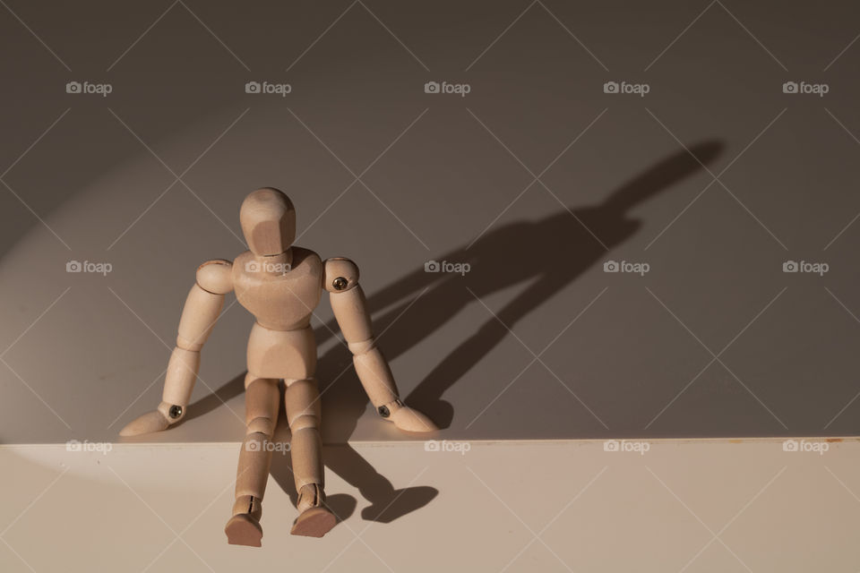 Mannequin sitting over the table edge, waiting