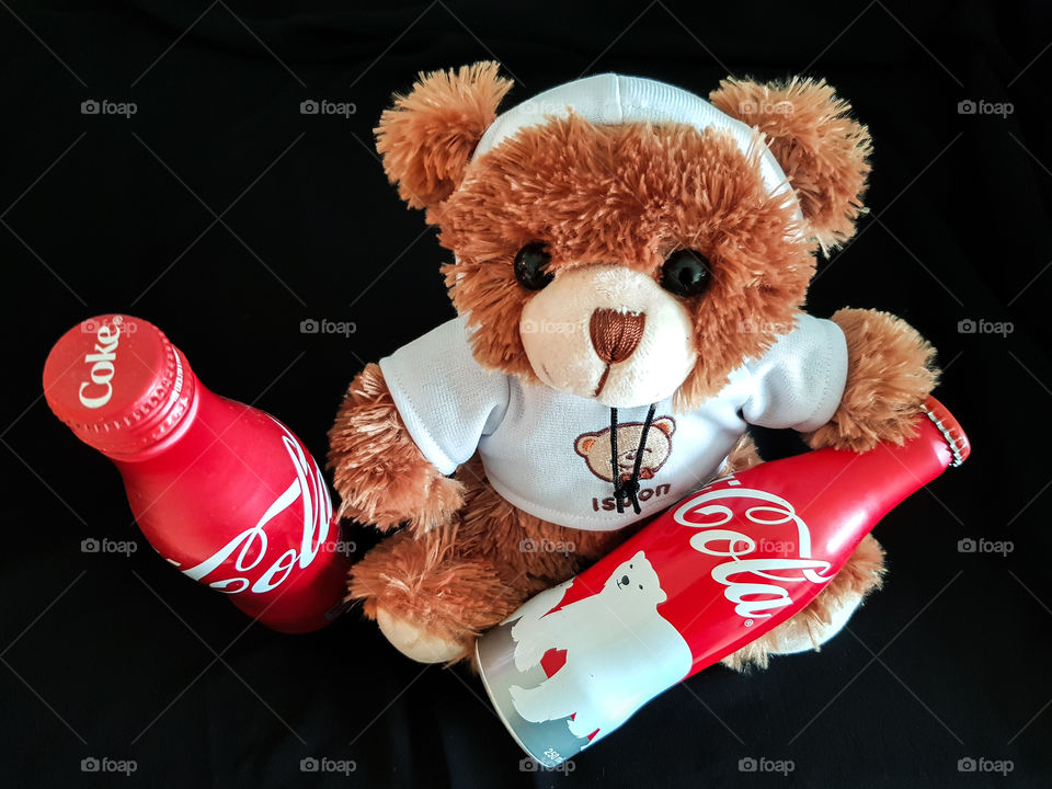 Adorable Bobo posed with its favourite bottles of coca cola. It just know how to have fun!