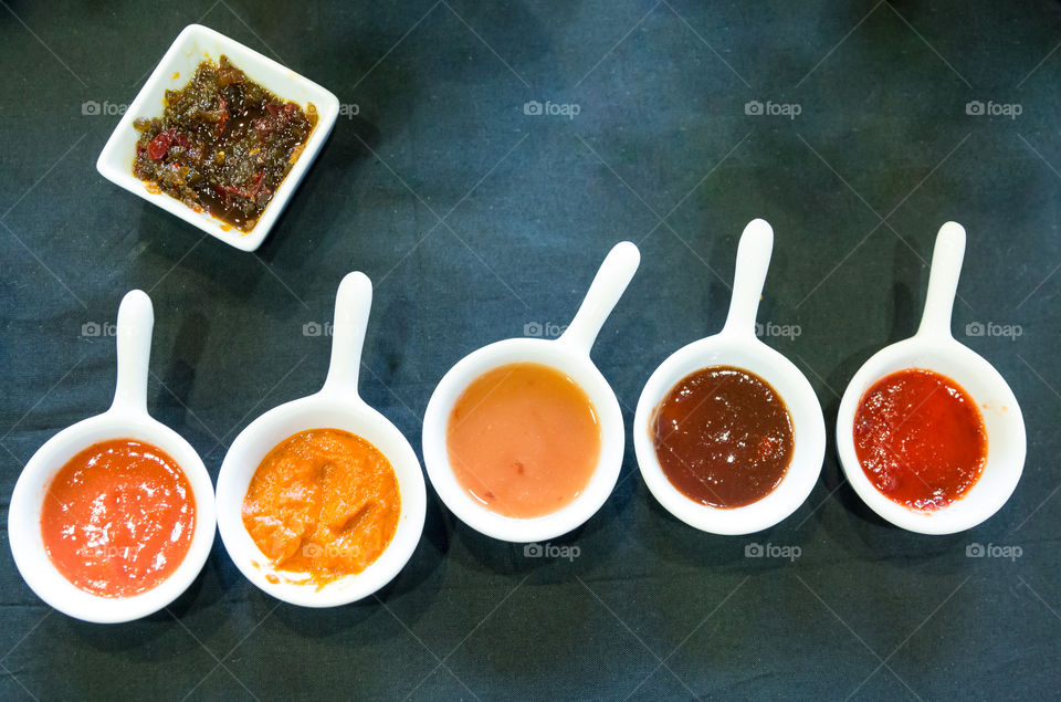 Variety Of Dip Sauces In White Bowls
