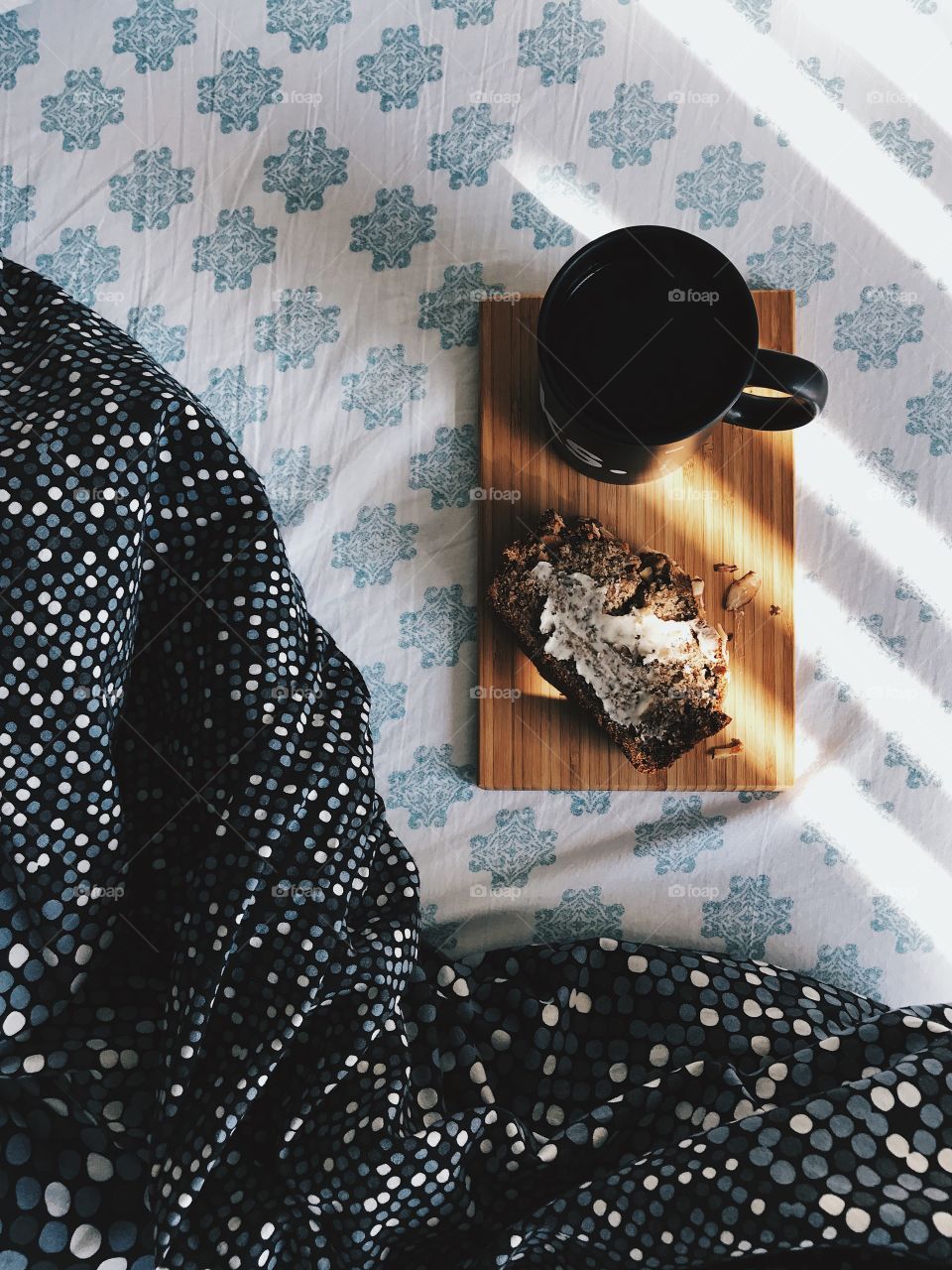 Coffee and banana bread on the bed. 