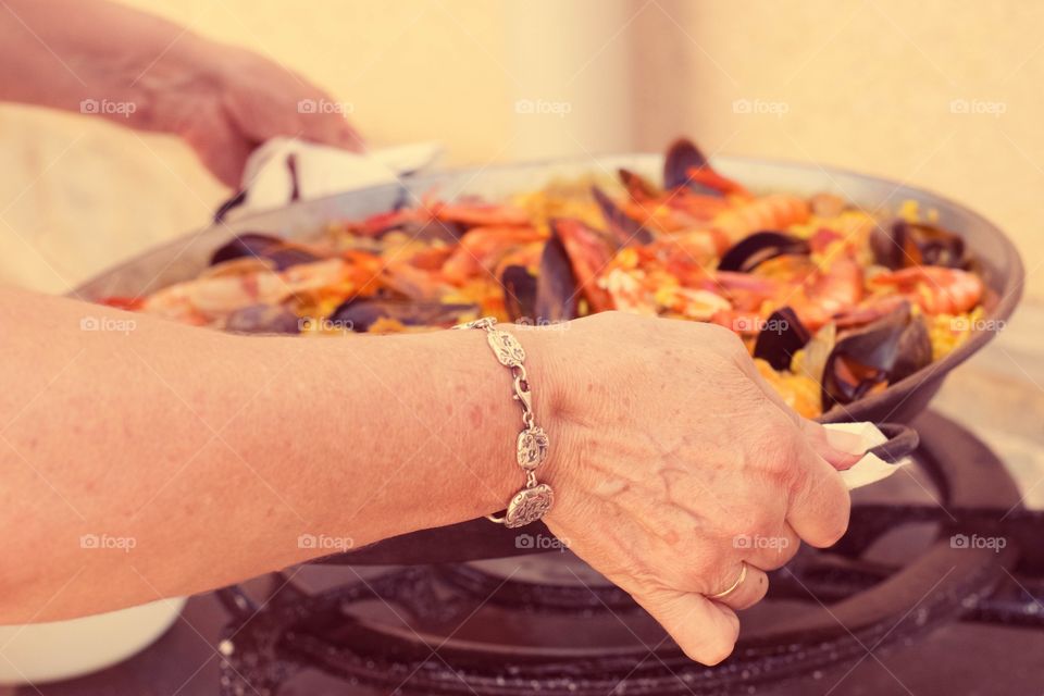 Close-up of paella cooking in gas
