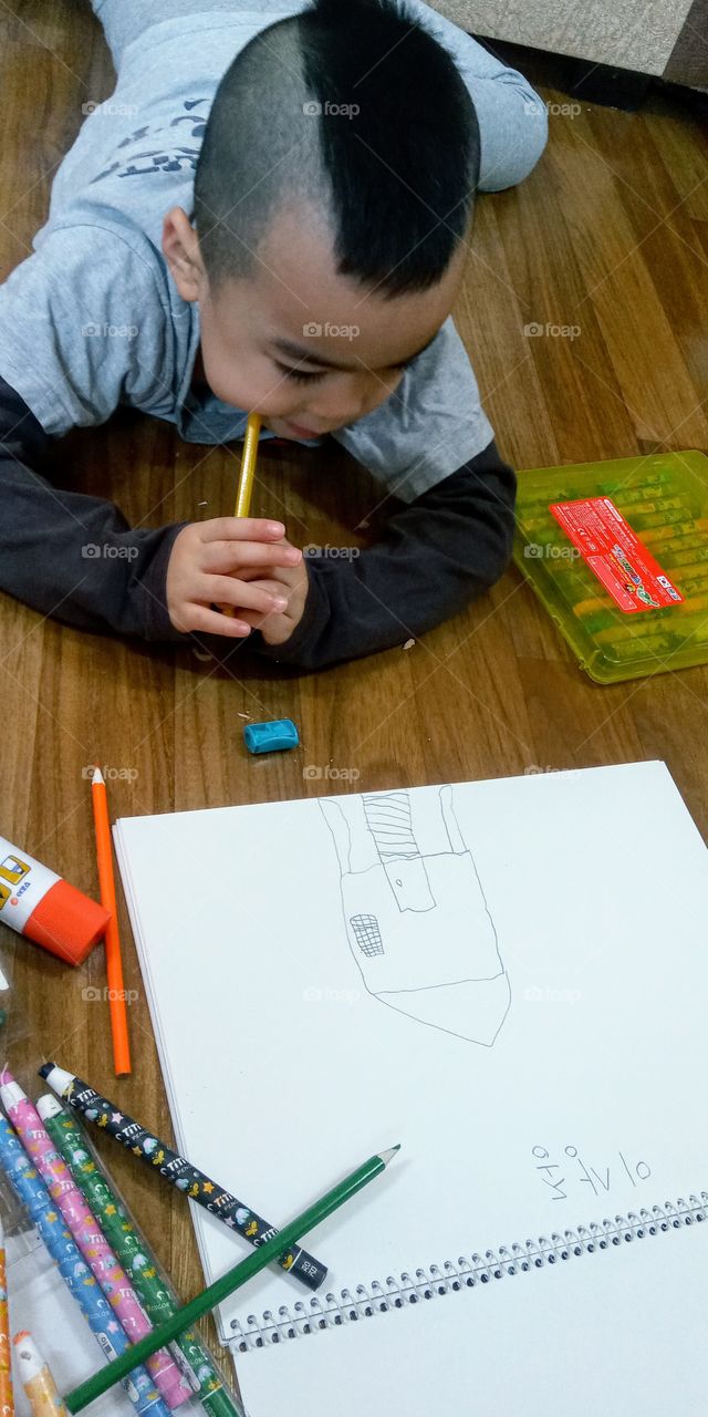 this little boy begin his drawing and he choose to draw a little house.
house is a sign of shelter and protection.