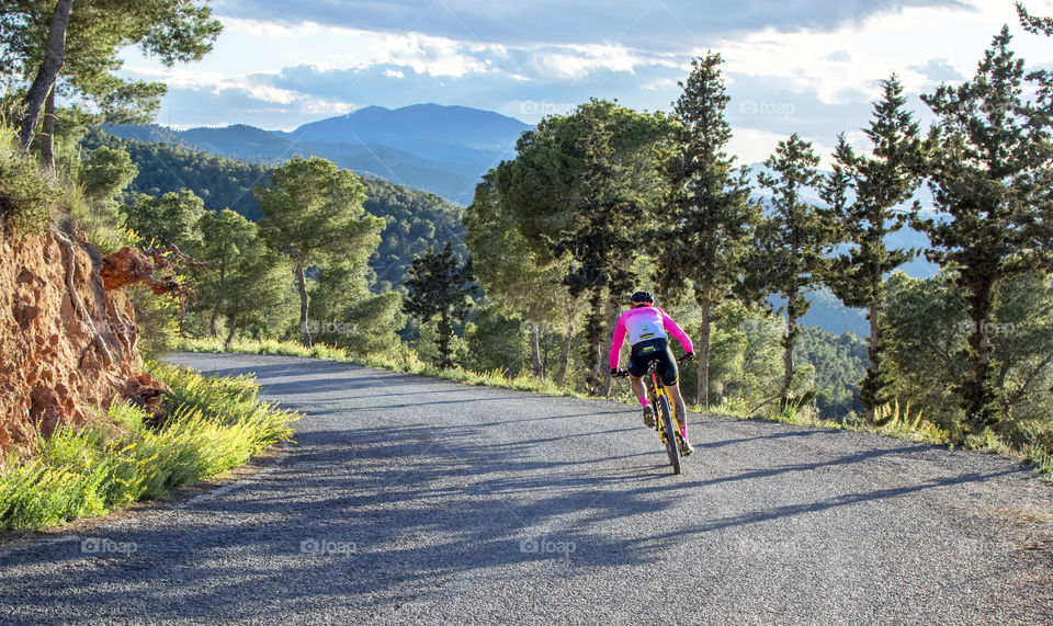 Man riding a mountain bike down hill