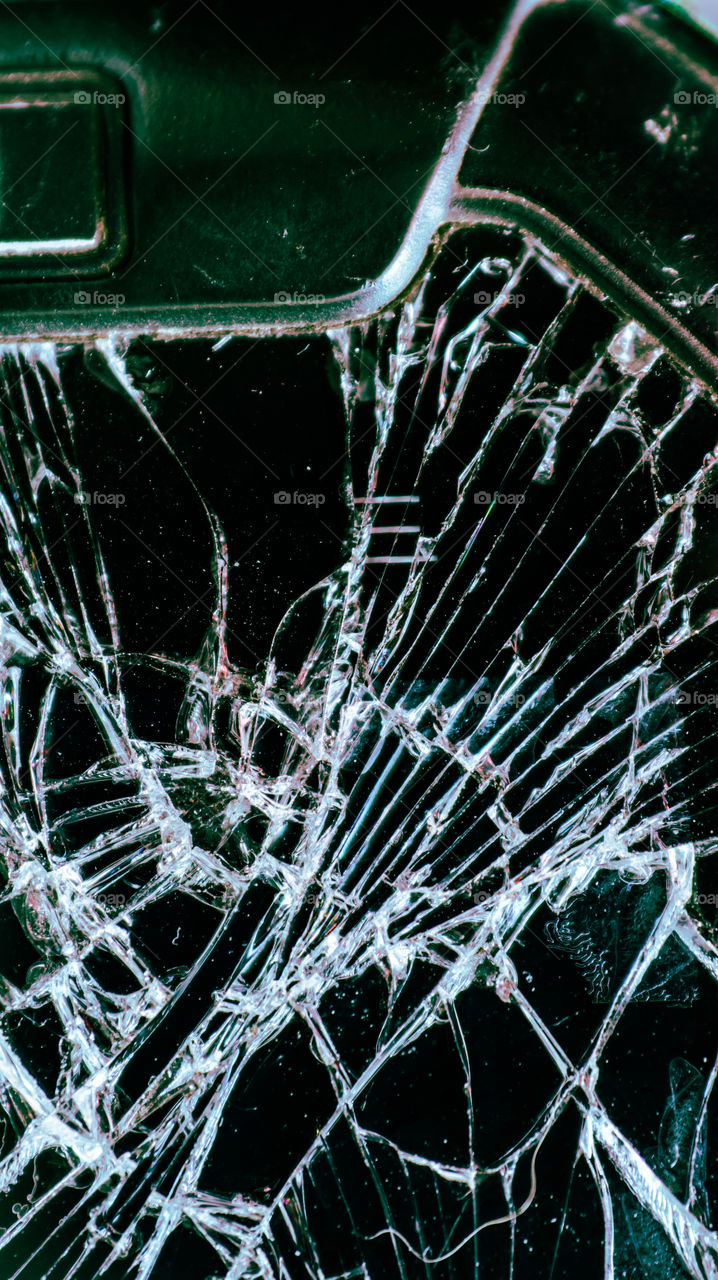 Multi-colored and bright broken smartphone screen close-up.