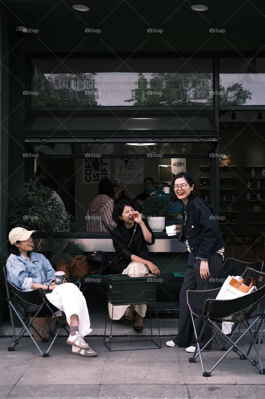 Female friendships, drinking coffee and chatting together 