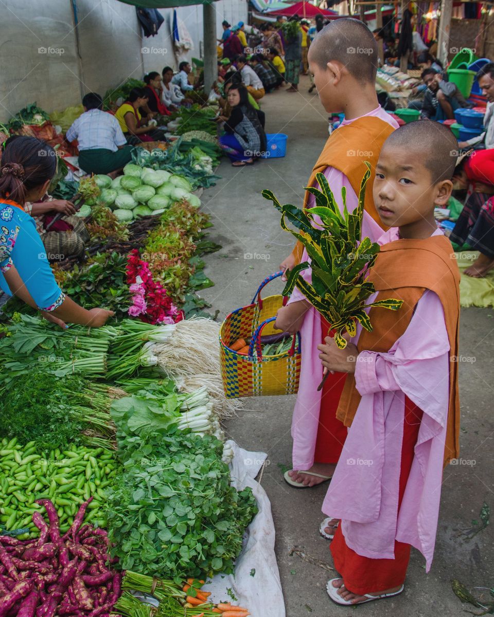 Nuns collecting alms in the market at Nyuang Shwe, Myanmar 