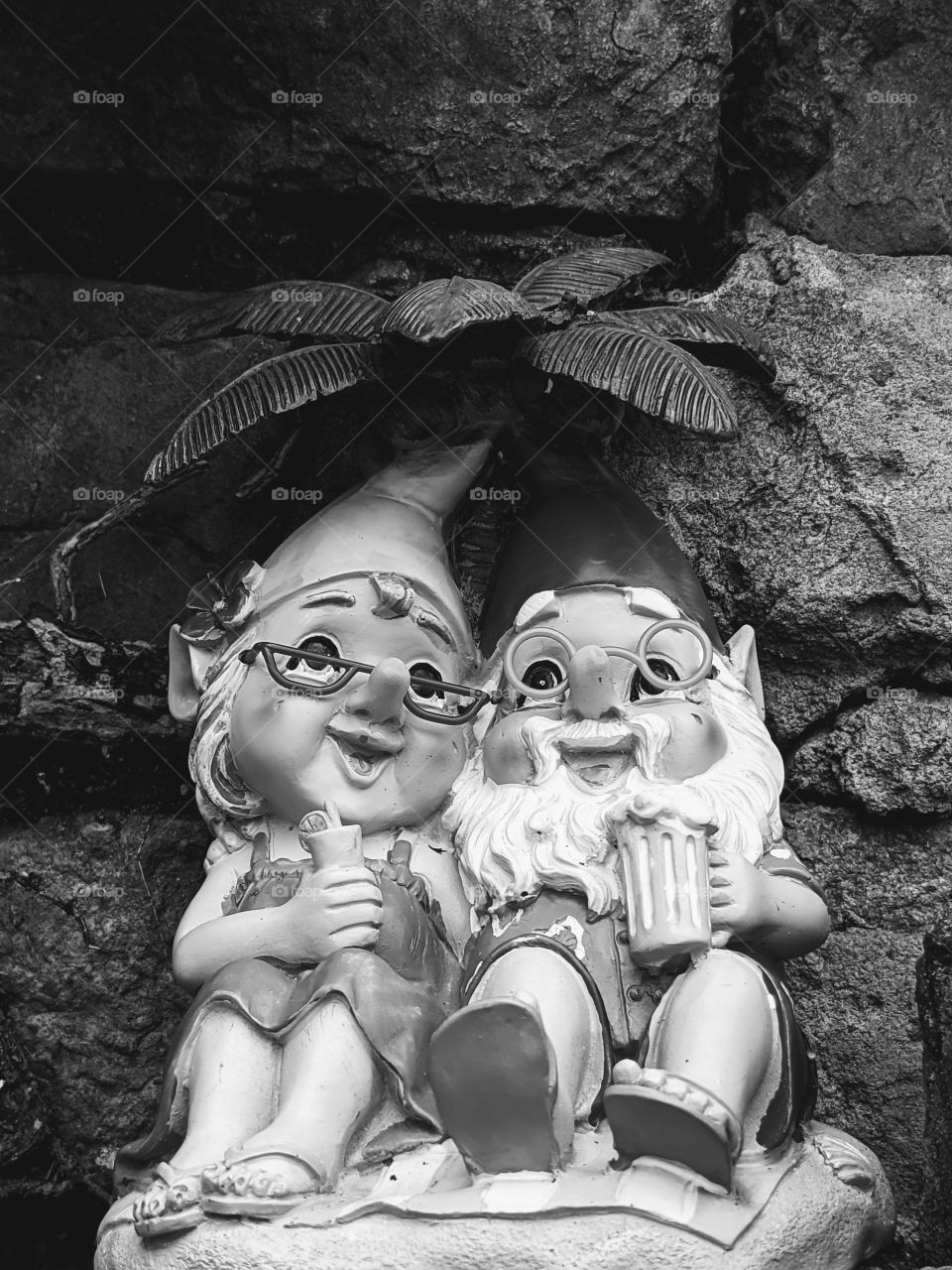 a gnome couple against brick background