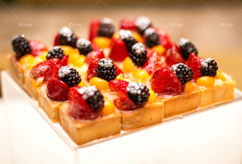Fresh fruit summer dessert with blackberries strawberries and citrus. Close up food image.
