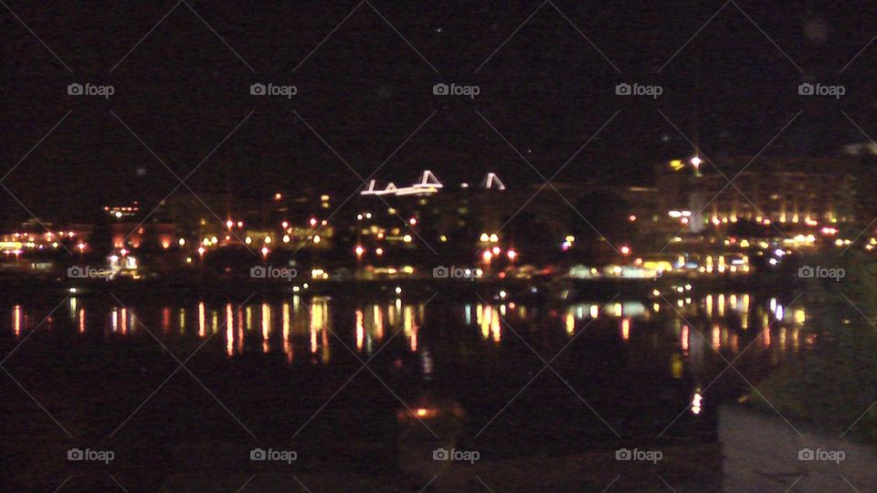 View of Seattle’s city lights at night reflecting on Puget Sound