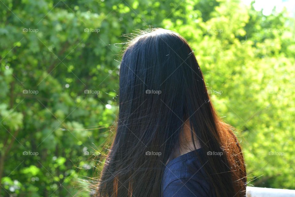 brunette hair woman green background