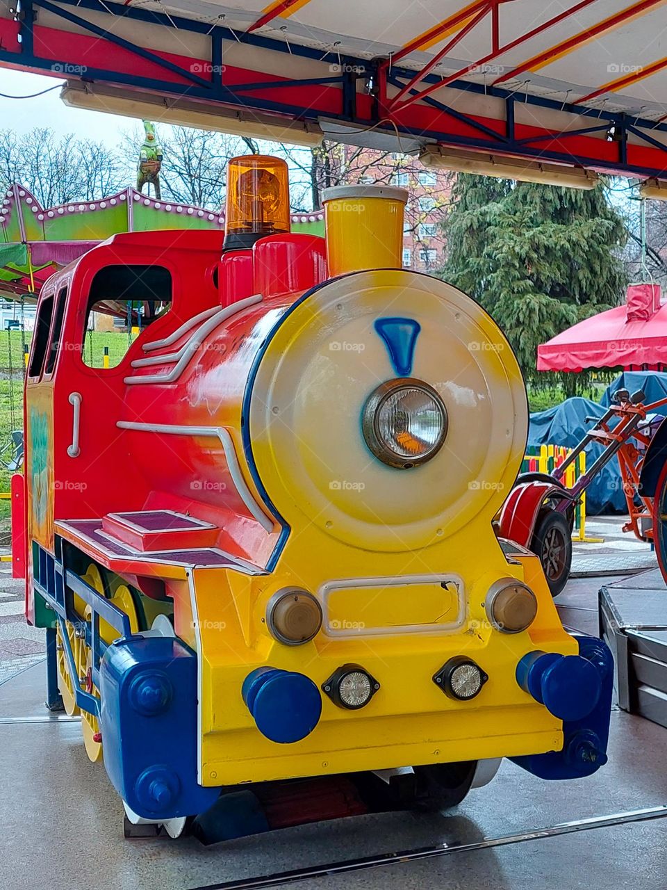 Colorful locomotive in the children's amusement park.  Dominance geometric shapes: circles,  triangle, and  rectangle