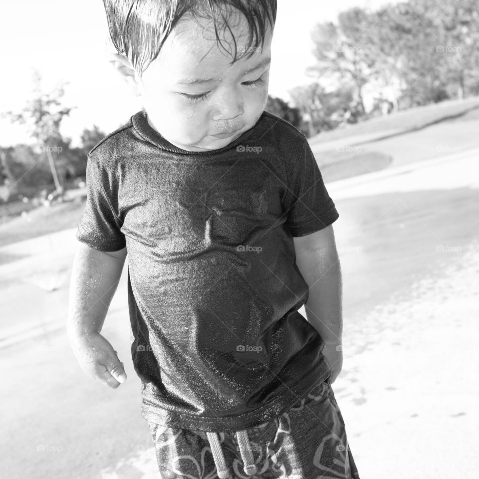 Wet but happy. Shy pic of my happy boy after playing at a splashpad 