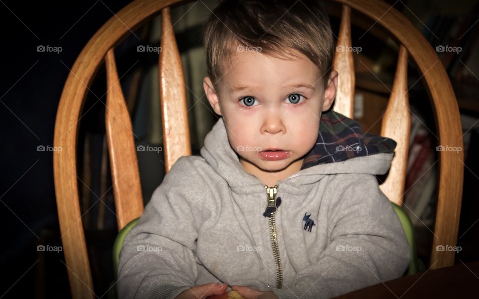 Eating his apple 