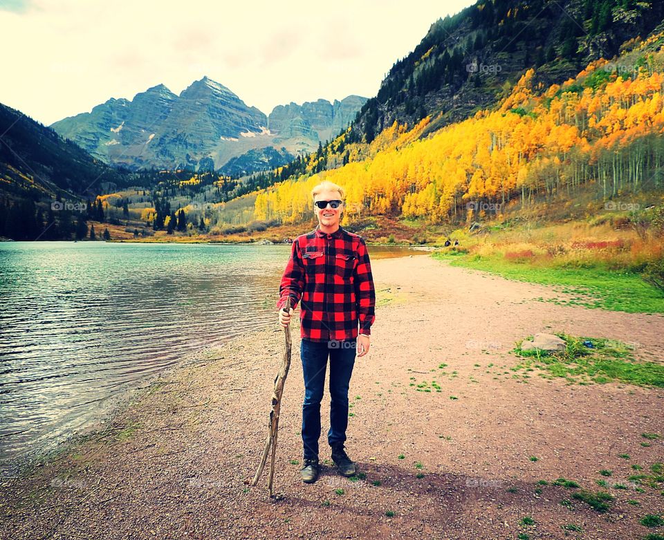 Young man standing near sea