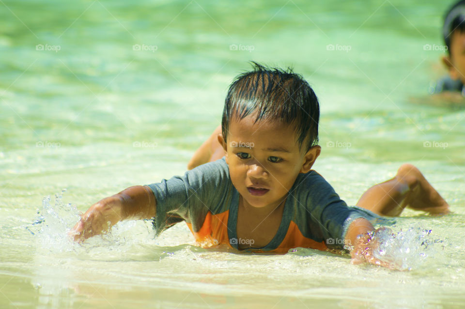 Boy swimming in pool