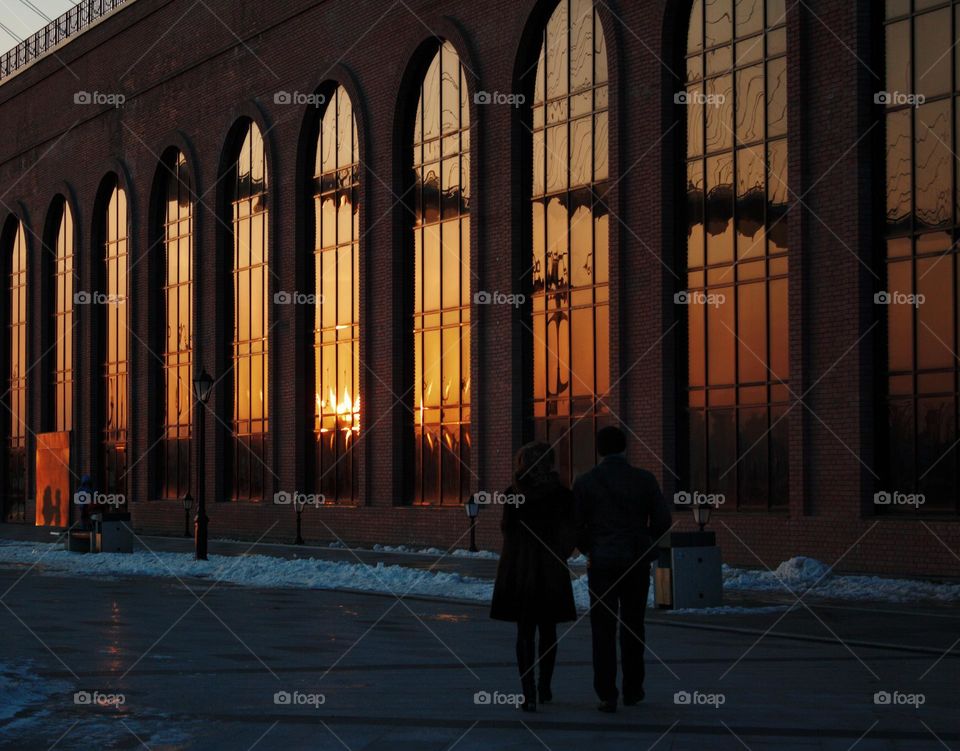 a building with large windows in the cold sunset