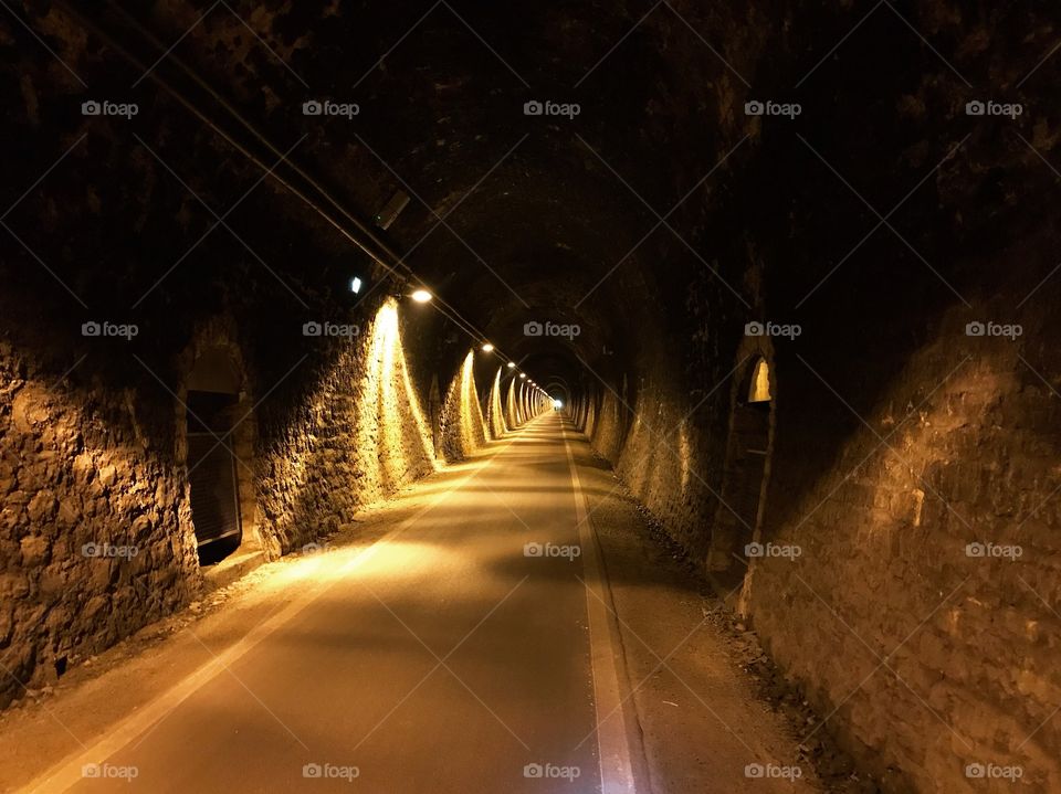 In the tunnel is illuminated with yellow light, creating a beautiful dark and light, very few people pass by.  mostly during the bike tour would pass it