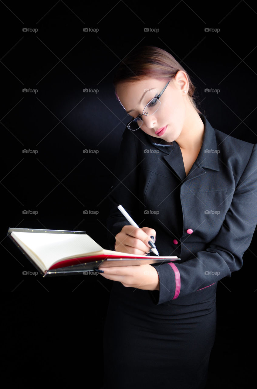 Woman on Phone Taking Notes