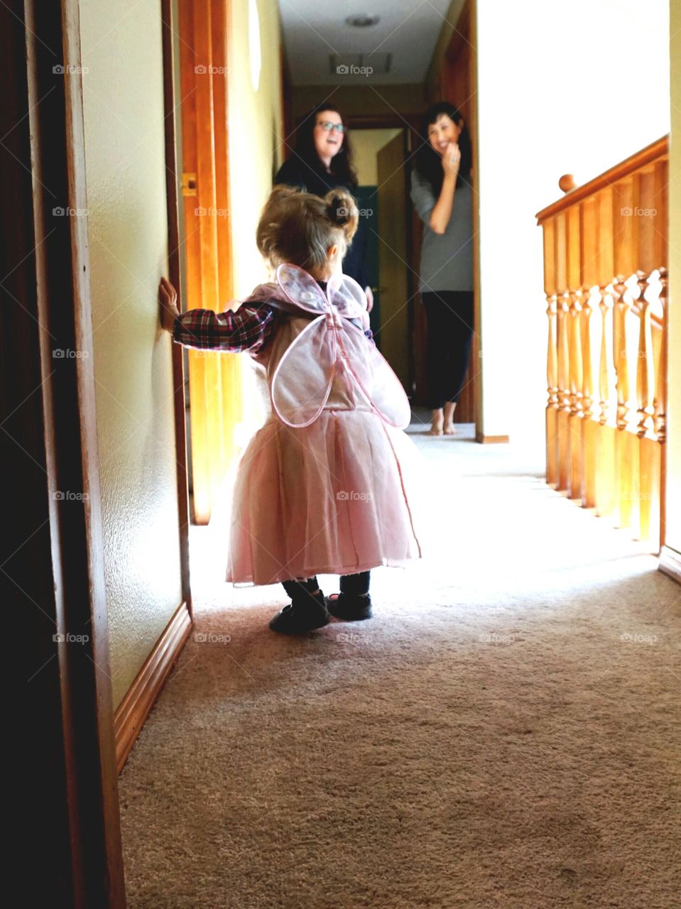 Rear view of baby girl standing with her wings