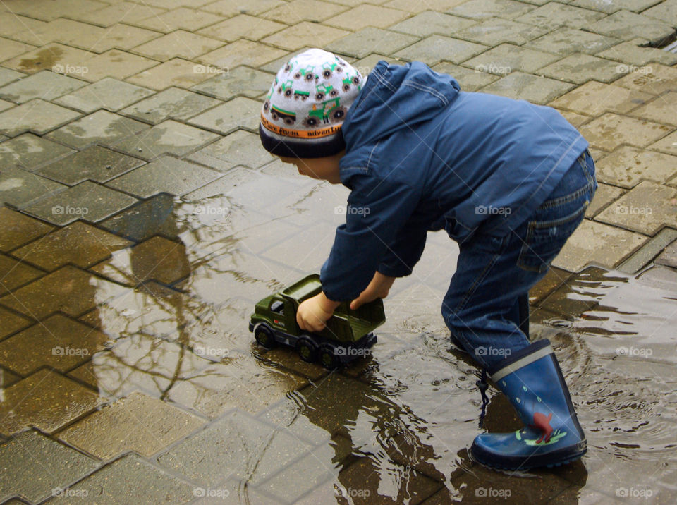 little boy playing in a pool