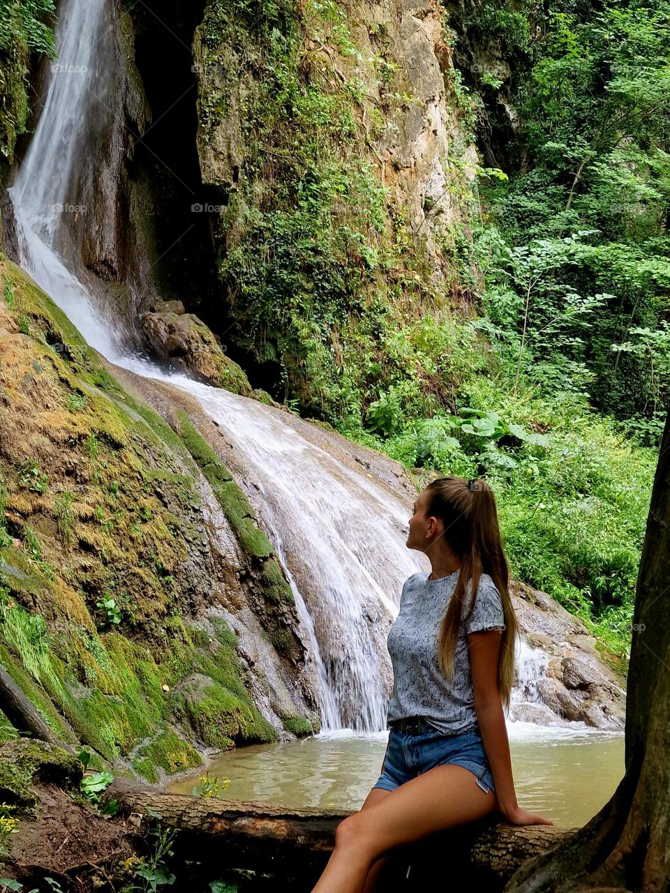 young girl admiring the Buraul Mare waterfall