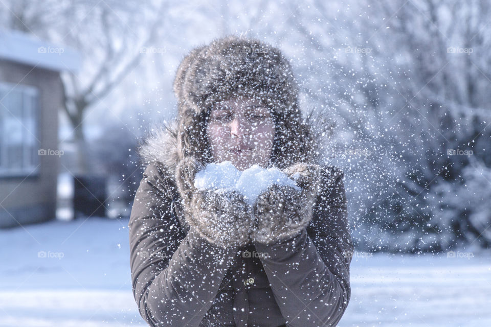 A female blowing snow