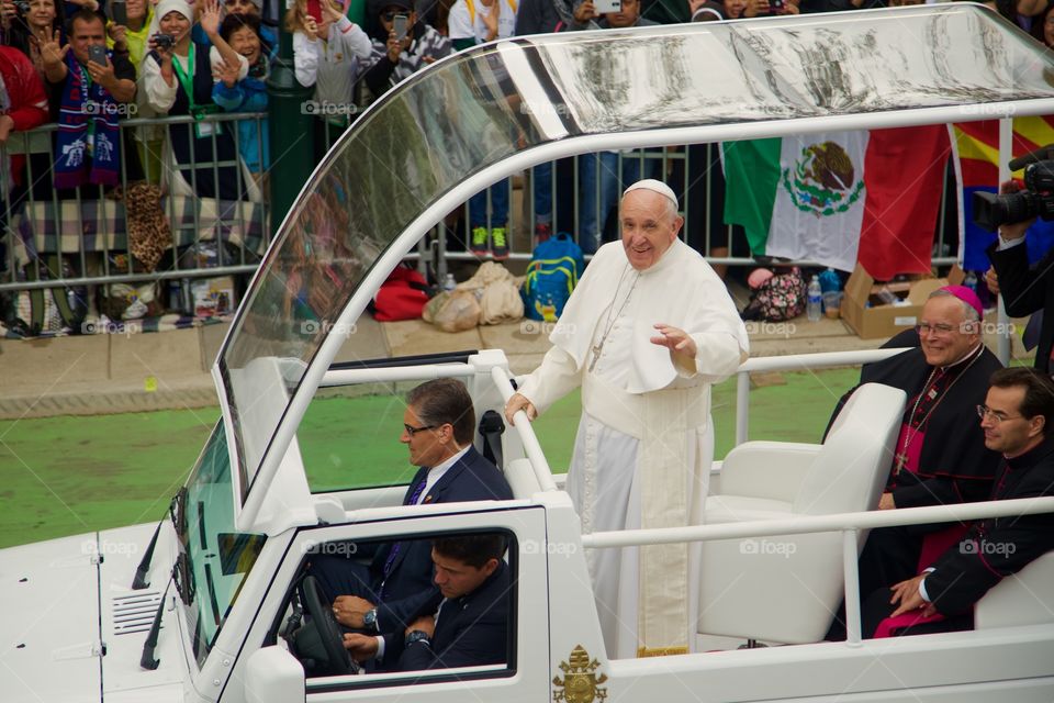 Pope Francis waves to the camera as he drives in the popemobile in Philadelphia in September 2015