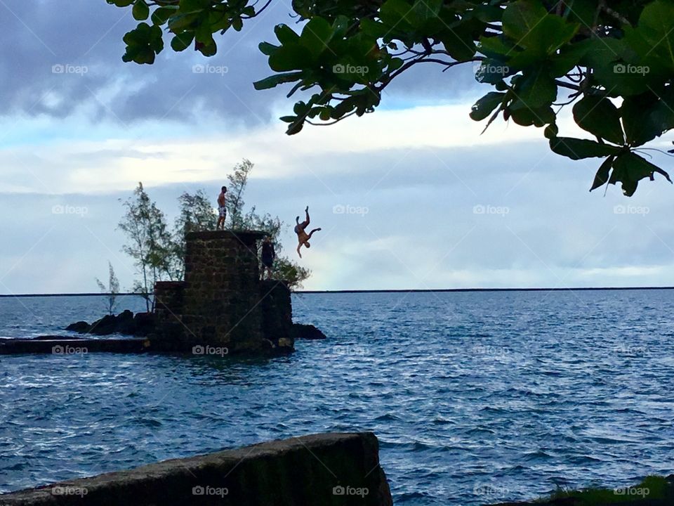 Boys jumping in Hilo Bay