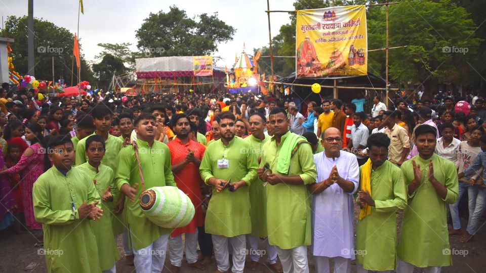 Kirtan troupe performing bhajan kirtan on Mahaprabhu Jagannath Rath Yatra in Musabani, Jharkhand, India . Crowd of devotees gathered to pull the chariot on the spot.
