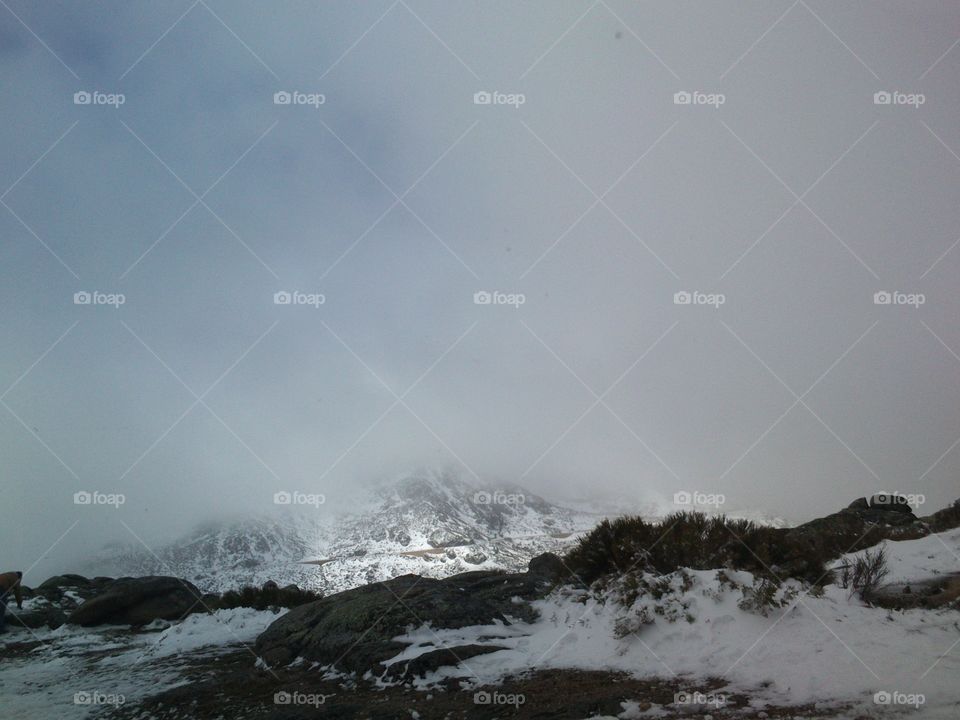 Snowy cloudy mountain landscape