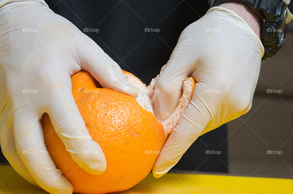 hands in white gloves cleanse the grapefruit