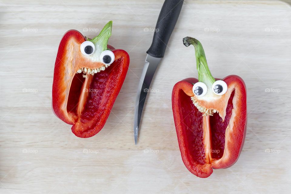 Organic juicy capsicum sweet pepper cut in half with googly eyes, fun concept