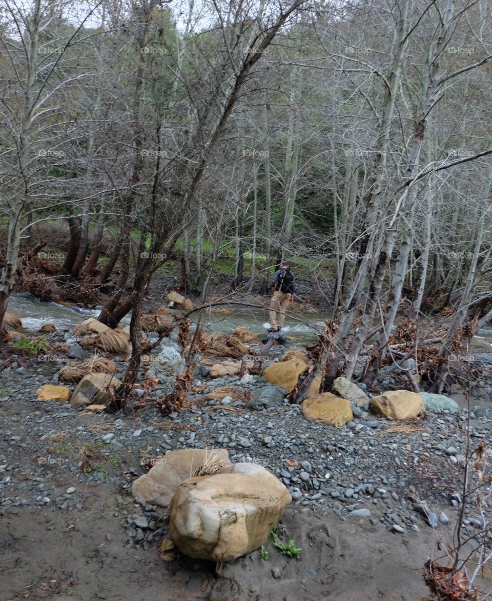 Hiker crossing a stream