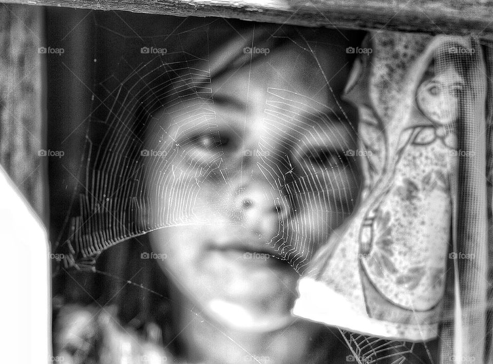 Girl and a spider web in the window