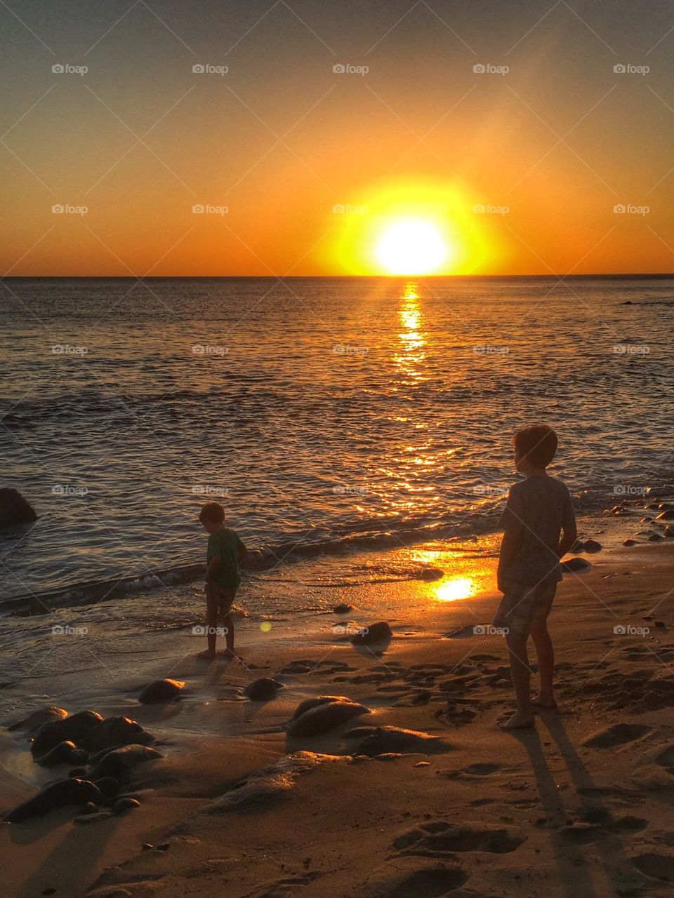 Children on the beach at sunset