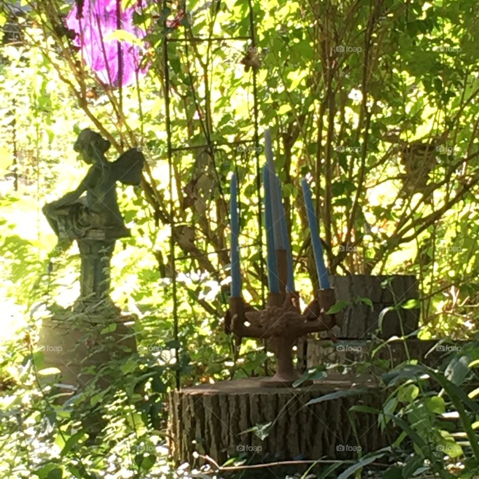 Fairy statue and candelabra in magical garden