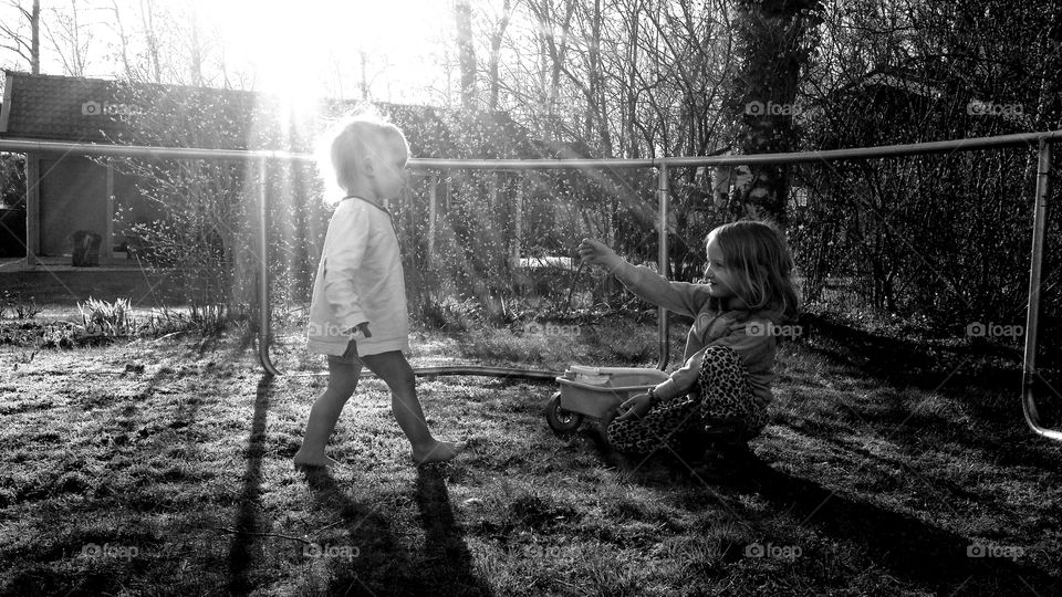 Two kids and sun shining on boy